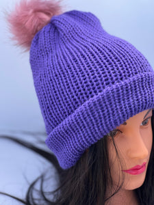 Solid dark purple knitted beanie with faux fur pom-pom