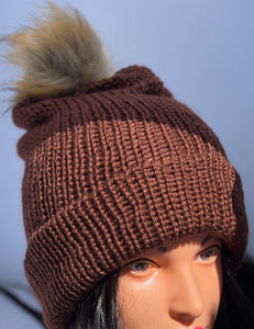 Dark brown knitted beanie with faux fur pom-pom