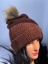 Dark brown knitted beanie with faux fur pom-pom