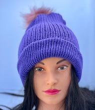 Solid dark purple knitted beanie with faux fur pom-pom